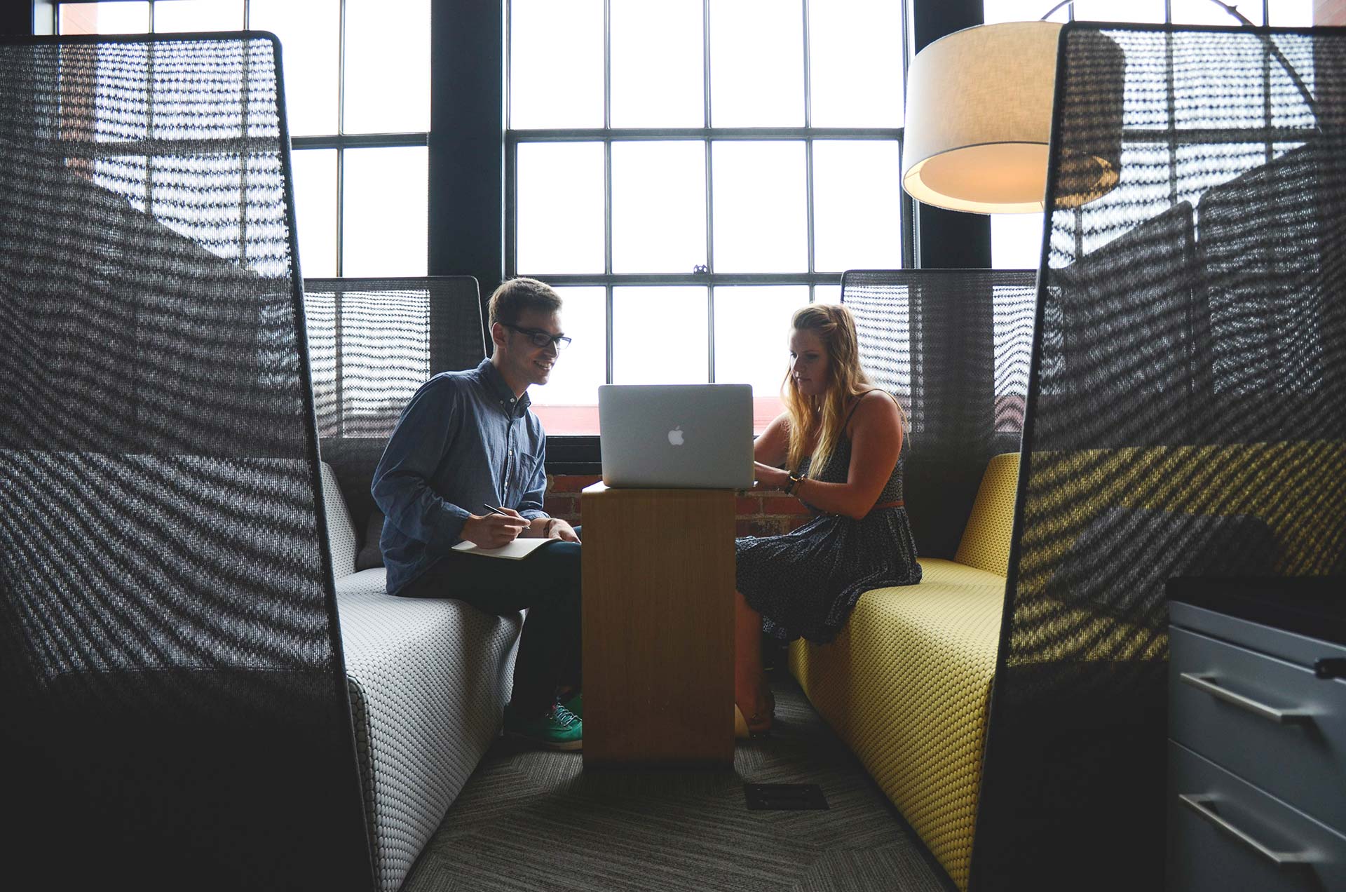 Two people working together on laptop.