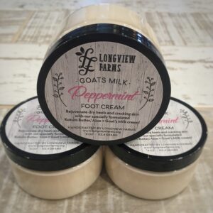 Three jars of lavender and rose-scented goat's milk body cream.