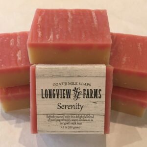 Stacked bars of pink and cream soap labeled 'Serenity' from Lowewen & Sons Farms.