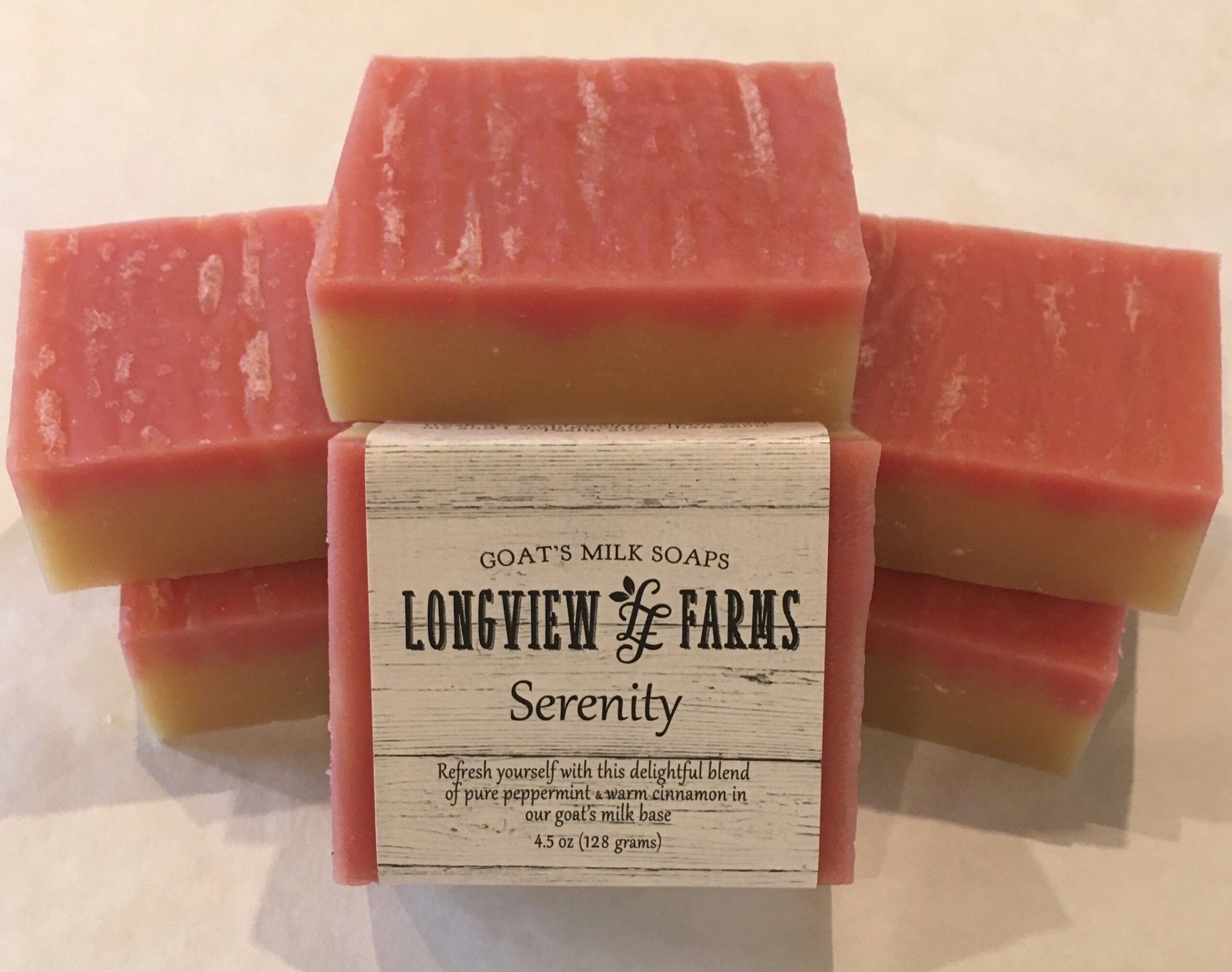 Stacked bars of pink and cream soap labeled 'Serenity' from Lowewen & Sons Farms.