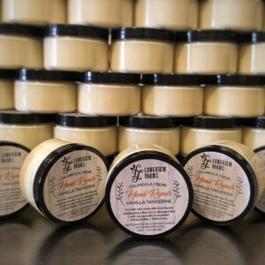 Multiple jars of shea butter skincare cream stacked in rows.
