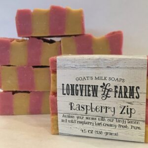 Stack of pink and yellow soap bars with a Raspberry Zip label.
