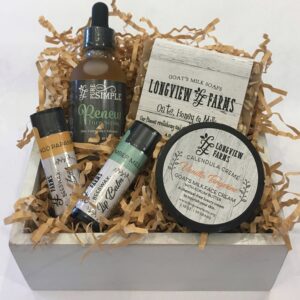 A natural skincare gift set with various products in a white box.