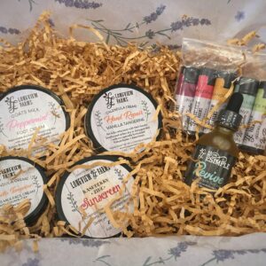 A gift set with scented soy candles and essential oils packed in shredded paper.